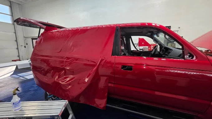 Red color change vinyl wrap being applied to panel van — Blue Rose Wraps Springfield OR