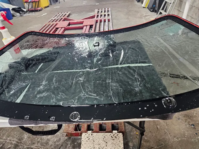 Window tint film application process on windshield — Blue Rose Wraps Springfield OR